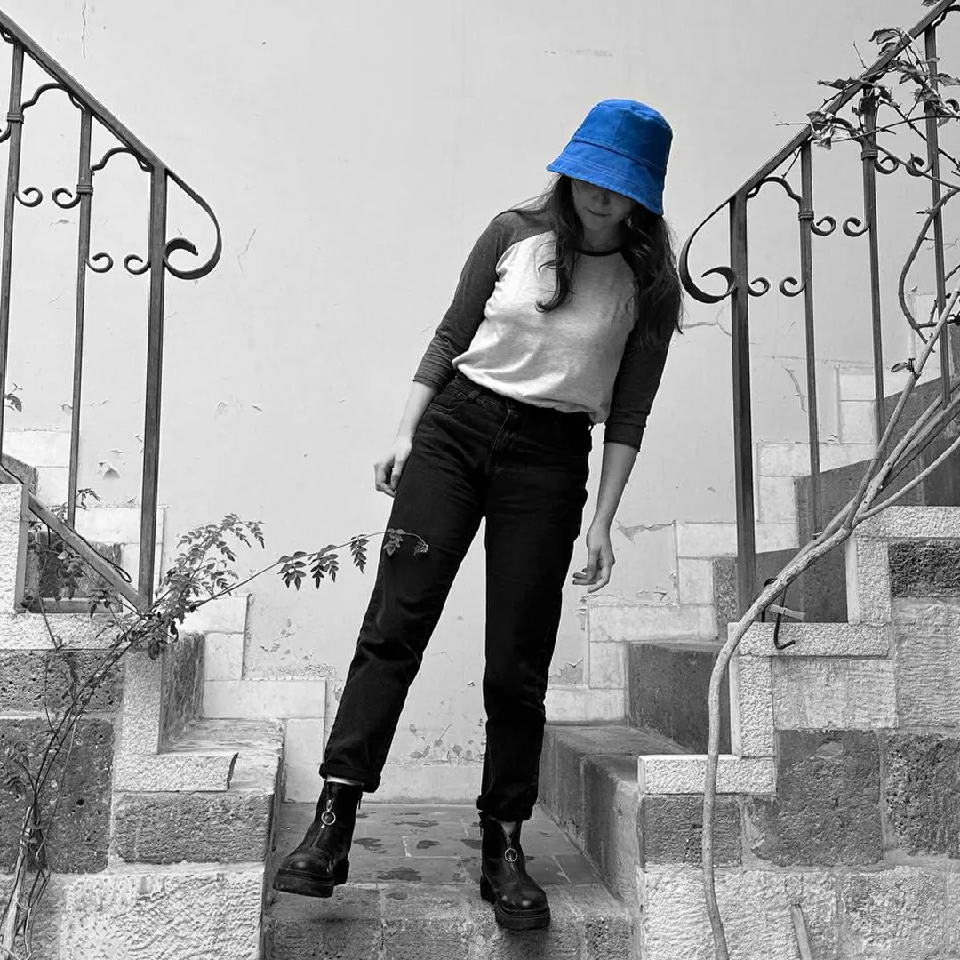 blue bucket hat on Damascus stairs